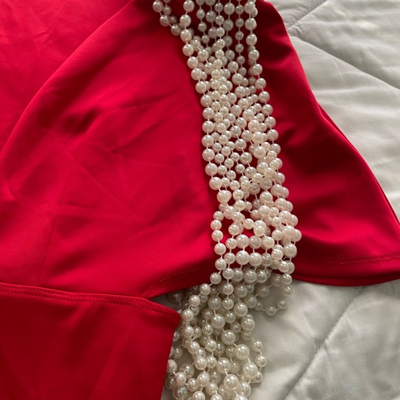 Vibrant Red Jumpersuit with structured pearl draped along shoulder pads. - Picture 3 of 5